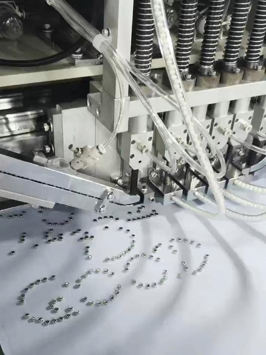 Close-up of industrial embroidery machine with active process showing intricate detailing for custom orders