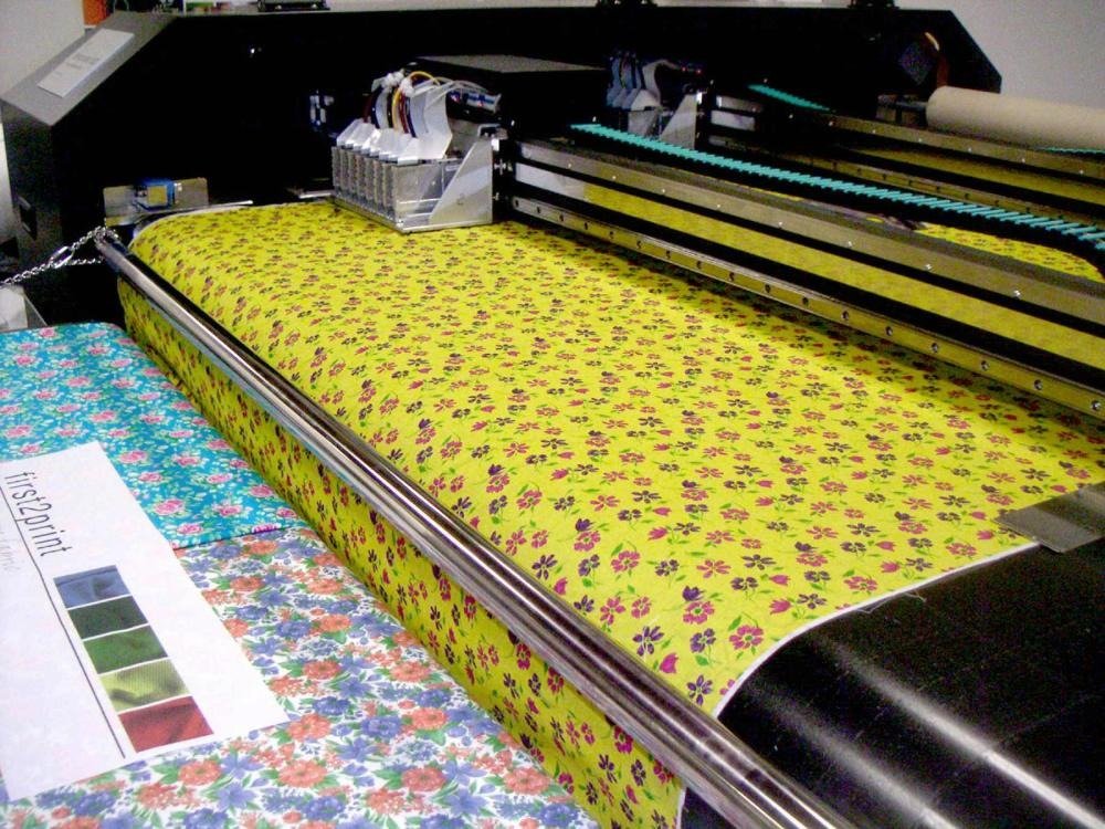 Detailed view of intricate fabric printing process at professional garment factory